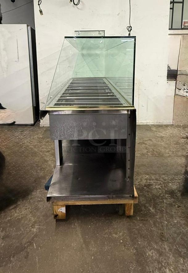 Stainless steel 12-pan steam table with glass sneeze guard, in good condition, by Steam Table.