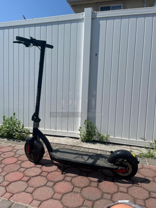 Hover-1 self-balancing electric scooter, black, 18 mph, LED, UL 2272 certified, in good condition on a patio.