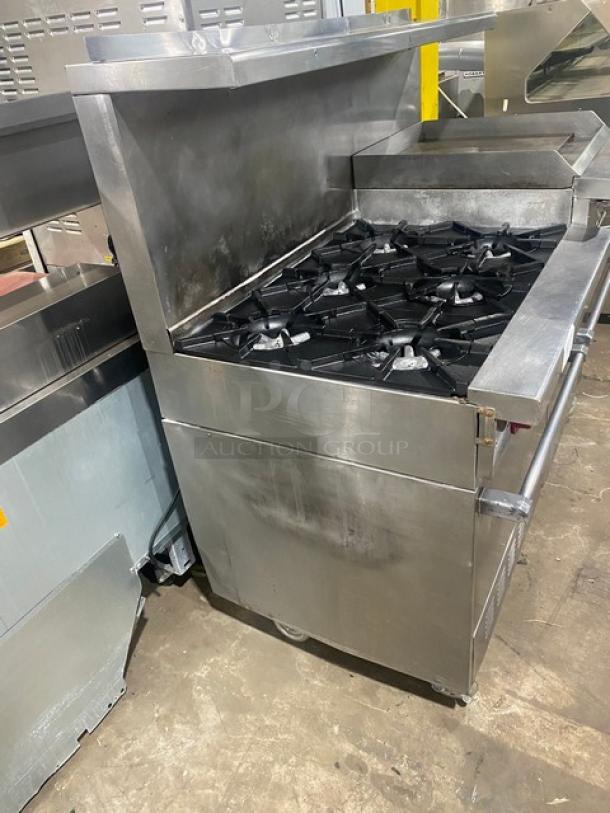 Garland H283 stainless steel 6-burner range with raised flat griddle, broiler/cheese melter, double oven, and salamander shelf.