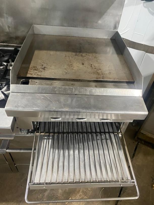 Garland H283 stainless steel 6-burner range with flat griddle, double oven, broiler, backsplash, and salamander shelf. Excellent condition.