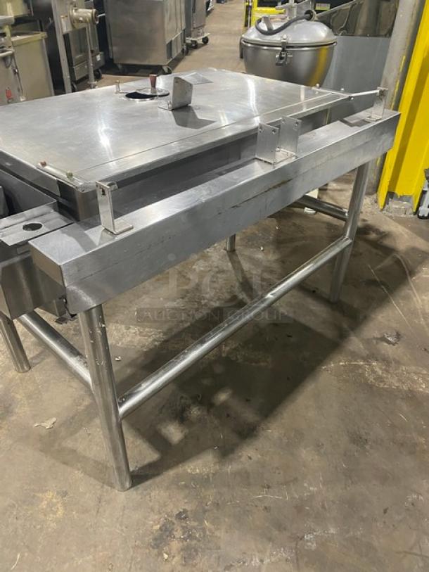 Commercial stainless steel tilt skillet/tilted braising pan, natural gas powered, on sturdy legs, industrial kitchen equipment.