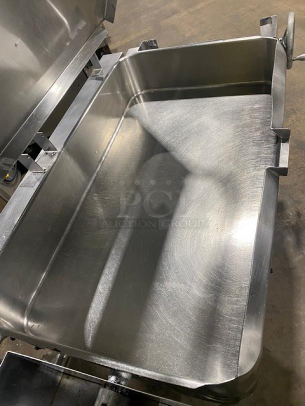 Commercial stainless steel natural gas tilt skillet/braising pan, excellent condition, mounted on legs, spacious interior.