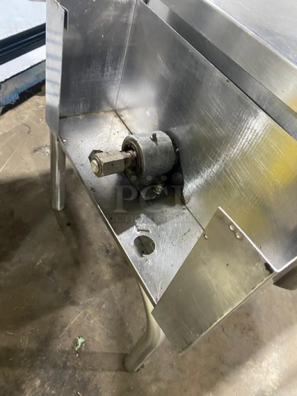 Commercial stainless steel natural gas tilt skillet/tilted braising pan on legs, sturdy construction, visible bolt system.
