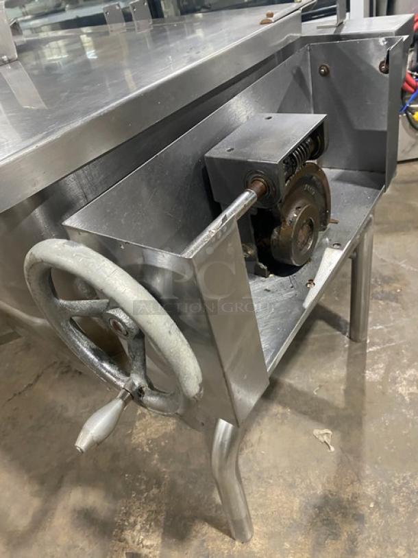 Commercial stainless steel natural gas tilt skillet on legs, showing tilt mechanism, in used condition.