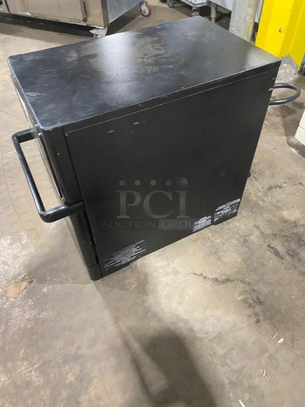 MerryChef black commercial countertop high-speed oven. Electric, 208/240V, 1 phase. Used condition, sturdy handles.