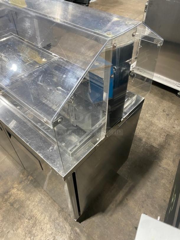 Turbo-Air JBT-60 stainless steel 2-door refrigerated buffet table with clear sneeze guard, on casters, in good condition.