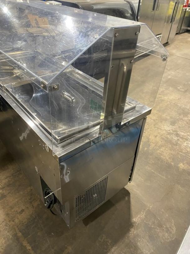 Turbo-Air JBT-60 refrigerated buffet table with clear sneeze guard. Stainless steel, on casters. Model: JBT-60, SN: JB6TA12016.