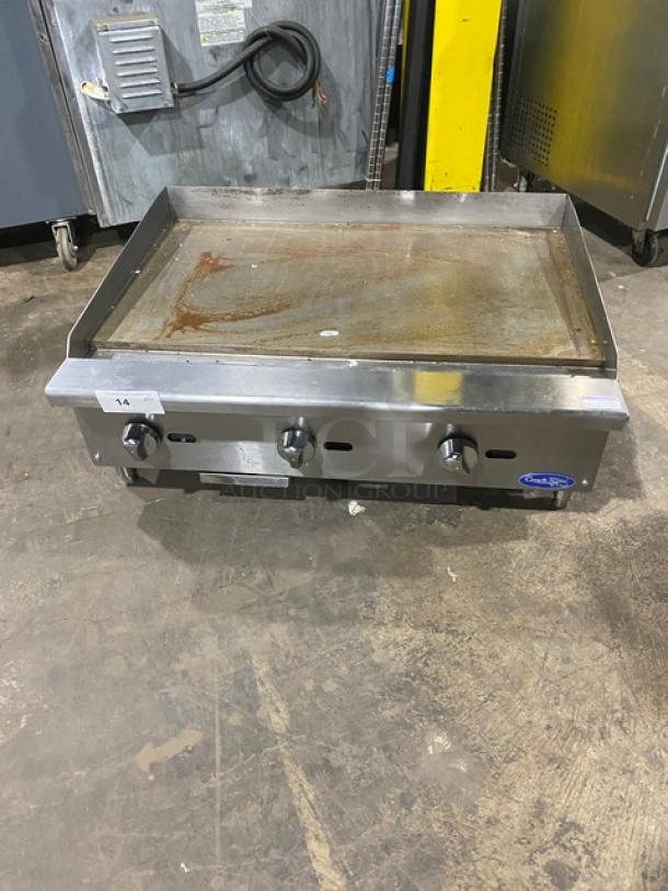 Cook Rite stainless steel commercial griddle, natural gas, with back and side splash, on legs. Used condition.