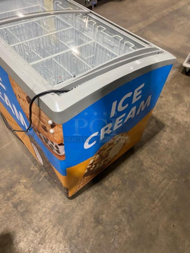Excellence VB5HC ice cream merchandiser chest freezer. White curved top, double sliding glass lid, poly coated wire baskets.