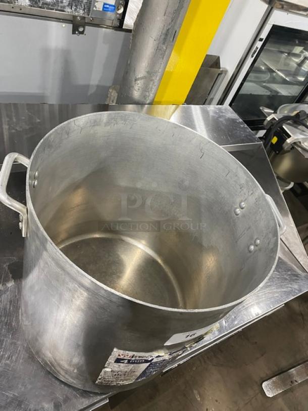 Winco commercial aluminum wide base stock pot with handles, showing visible wear.