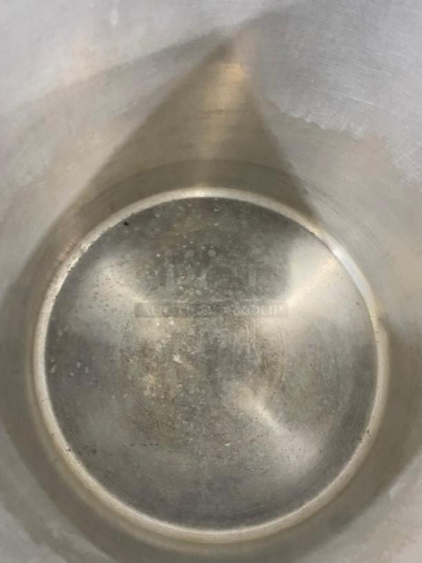 Winco commercial aluminum wide base stock pot with handles. Interior shows light wear. Durable for heavy-duty use.