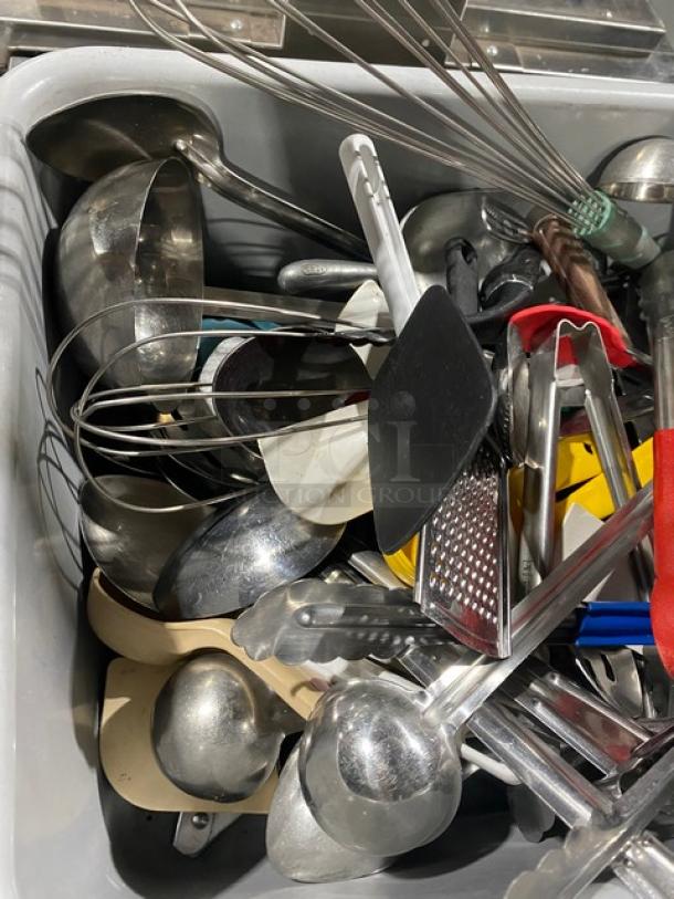 Assorted commercial kitchenware and utensils, including ladles, whisks, and tongs, in used condition, all for one price.