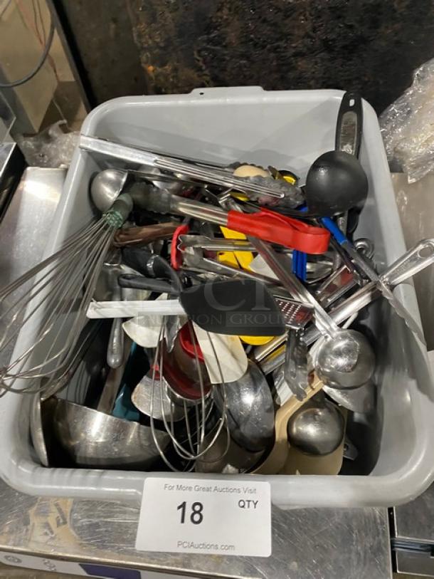 Lot of commercial kitchenware and utensils in a plastic bin, including whisks and ladles. Mixed condition.