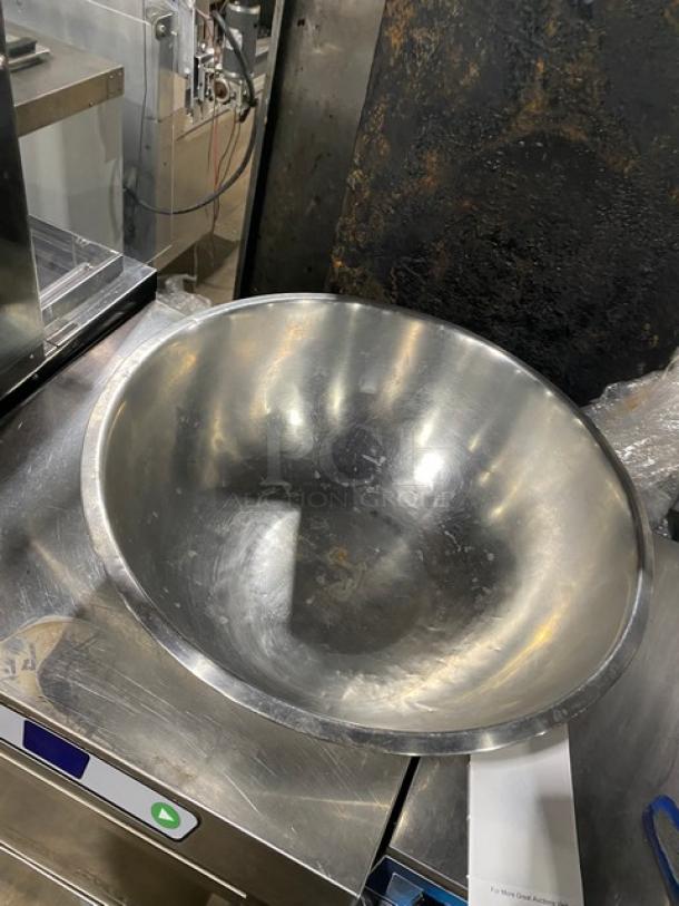 Commercial stainless steel mixing/prep bowl, large size, reflective finish, used condition with visible wear, no labels present.