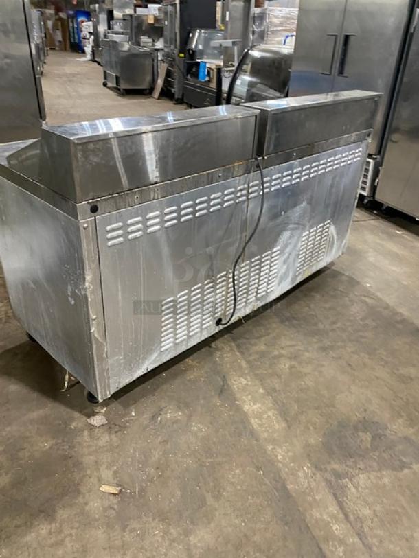 Continental SW72-18 stainless steel refrigerated prep table, three-door, on casters, with polly coated wired rack, used condition.