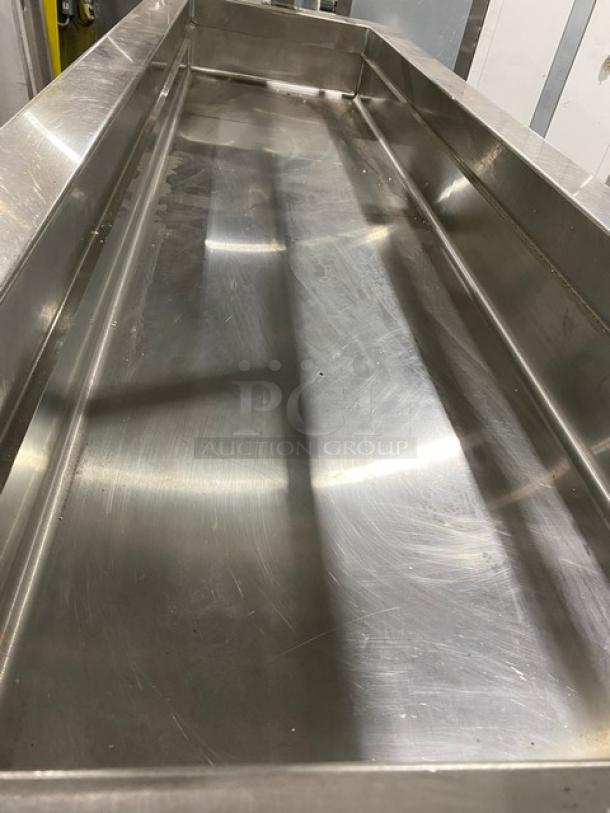 Servolift stainless steel refrigerated salad bar with overhead sneeze guard and foldable tray slide, model 502-6R-CW, on casters.