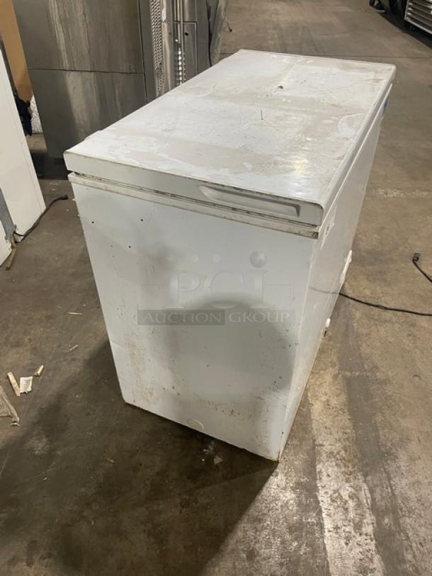 GE Appliances commercial white chest freezer, model FCM7SUFWW. Shows wear; visible scratches and marks. 115V usage.