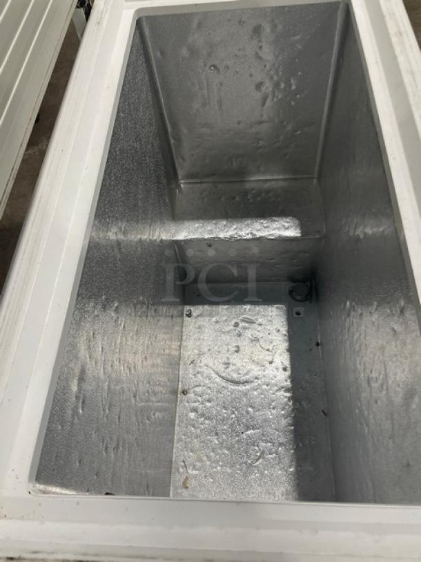 GE Appliances chest freezer, model FCM7SUFWW, white interior, shows spacious interior and good condition.