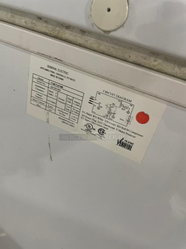 GE Appliances white chest freezer model FCM7SUFWW, commercial use, 115V, visible product label with specifications.