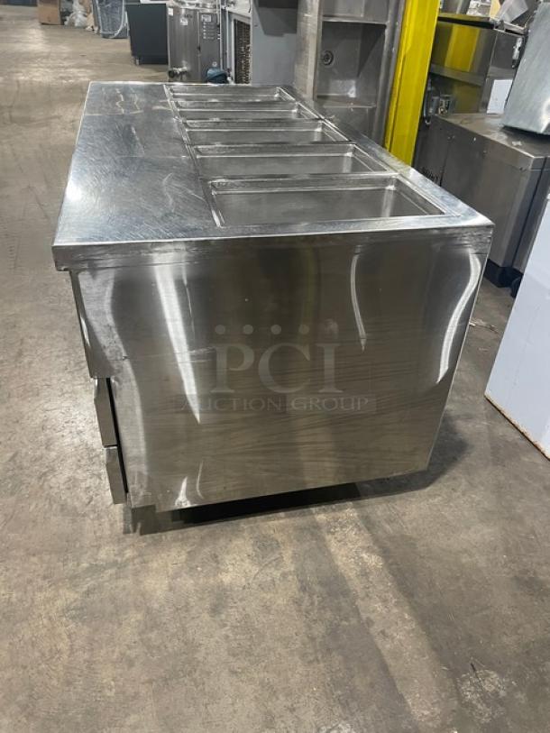 Delfield stainless steel 4-drawer refrigerated 5-bay salad bar, model 18MC68PEF, on casters, with enclosed undershelf.