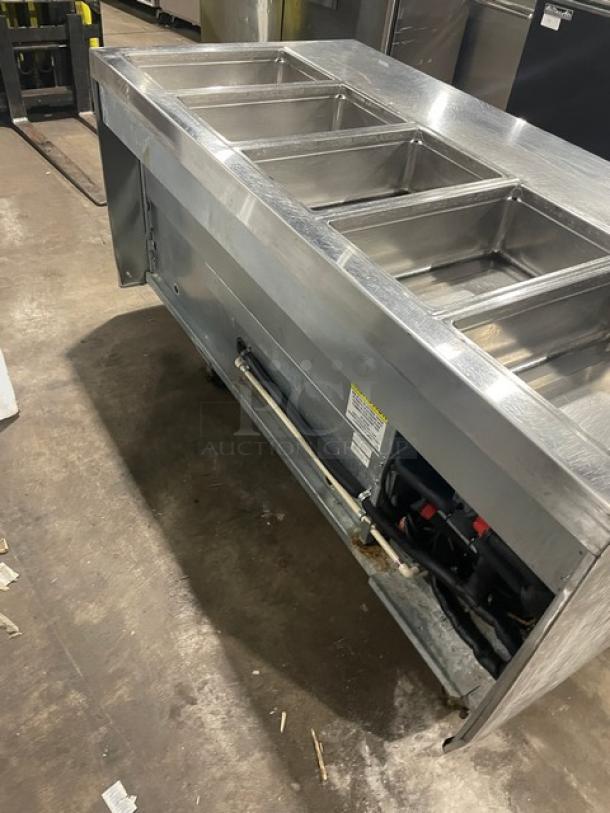 Delfield stainless steel refrigerated salad bar, model 18MC68P-EF, with four drawers, five bays, and enclosed undershelf on casters.