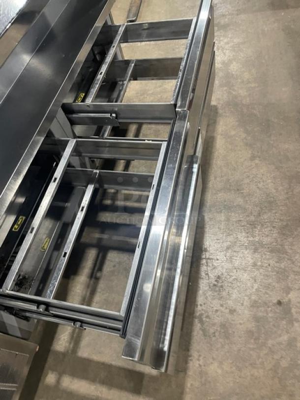 Delfield stainless steel 4-drawer refrigerated salad bar, Model 18MC68P-EF, on casters, with enclosed undershelf.