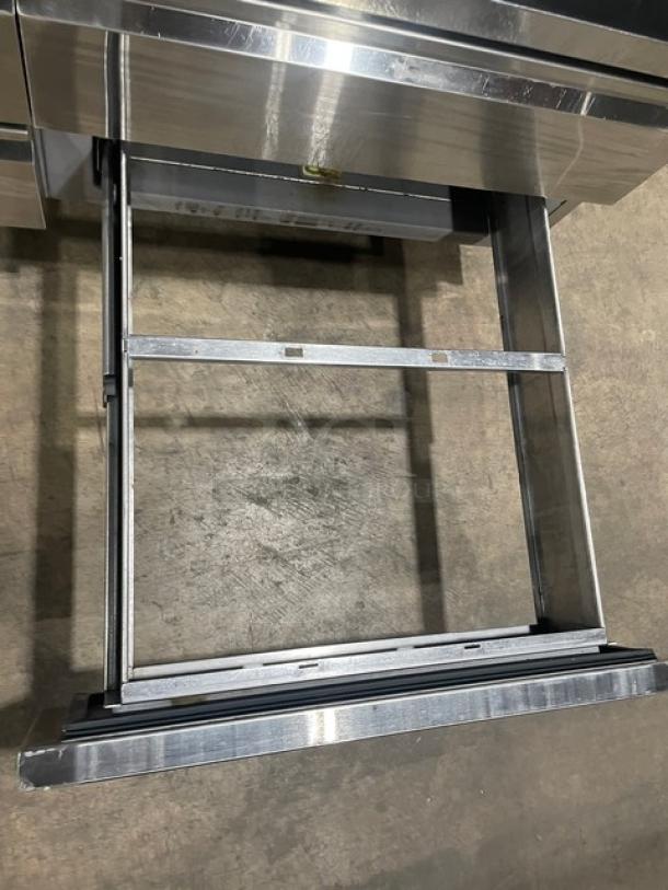 Delfield commercial stainless steel 4-drawer refrigerated salad bar, model 18MC68PEF, on casters, in clean condition.