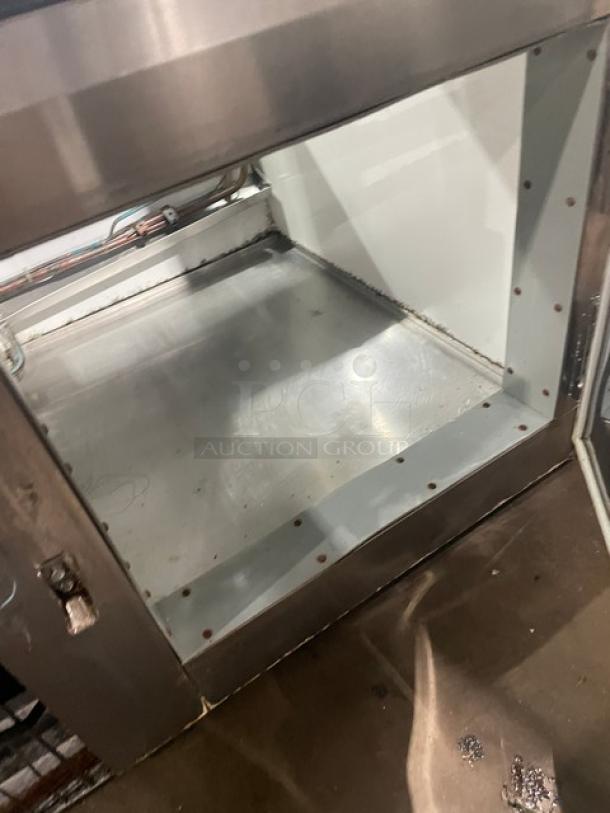 Custom Cool stainless steel refrigerated deli display with slanted glass, multi-tier shelving, double sliding glass doors, and lower storage.