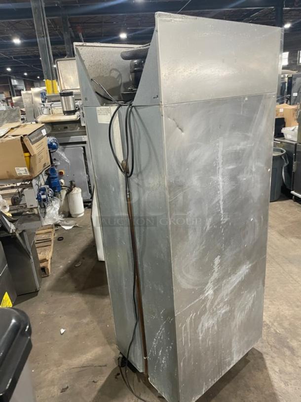 Continental stainless steel reach-in refrigerator, model 1RN, with built-in pan slides. On casters. Used condition.