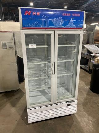 Commercial white double glass swing-door reach-in refrigerator, model LG800BF, on casters, with poly coated wire racks.