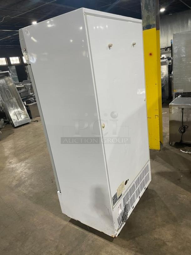 Commercial white double glass swing-door refrigerator, model LG-800BF, poly coated wire racks, on casters, 220V, side view.