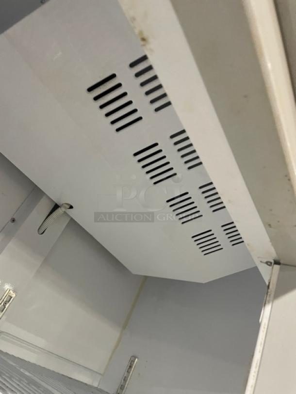 Commercial double glass swing-door refrigerator, Model LG-800BF, features poly-coated wire racks, 220V, on casters, white interior.