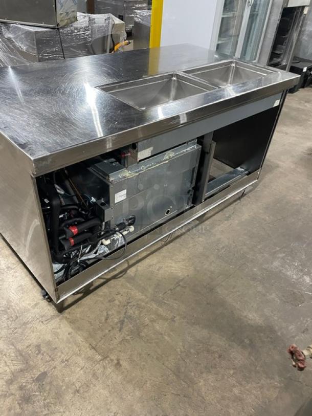Delfield stainless steel refrigerated prep table, model 18SC39P-EF, with triple storage, visible on casters, good condition.