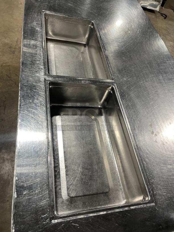 Delfield stainless steel refrigerated salad/sandwich prep table, model 18SC39P-EF, featuring dual compartments, on casters.