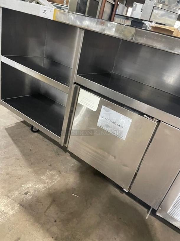 Delfield stainless steel refrigerated prep table with single door, model 18SC39P-EF, triple storage, on casters.