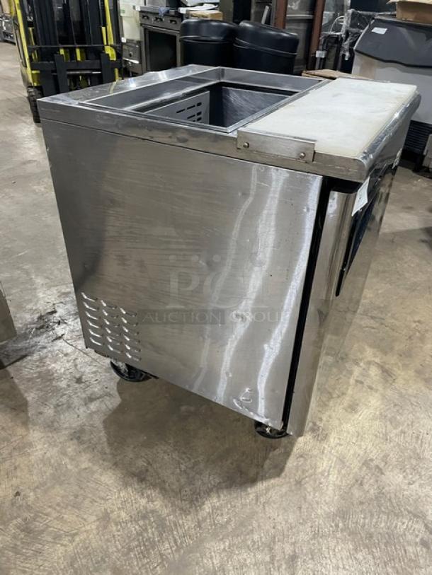 Turbo Air TST-28SD stainless steel prep table with cutting board, single door, refrigerated, on casters.