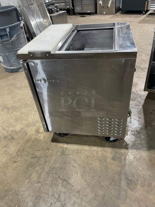 Turbo Air TST-28SD commercial stainless steel refrigerated salad/sandwich prep table with cutting board, on casters.