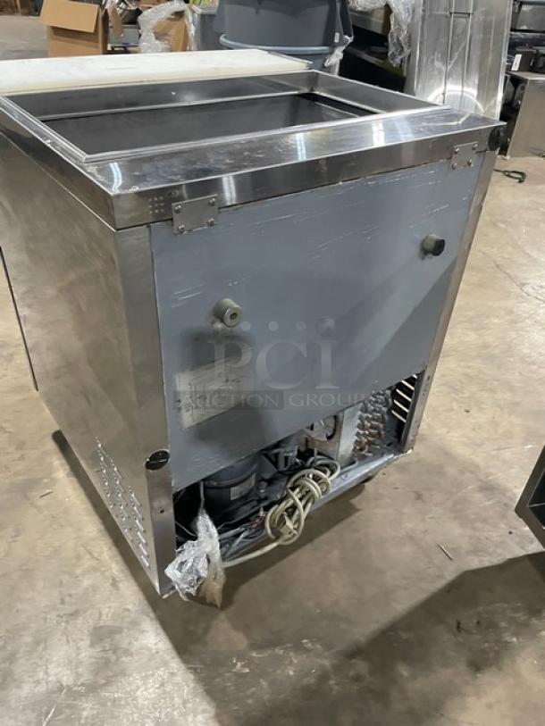 Turbo Air TST-28SD stainless steel refrigerated prep table, includes cutting board, 115V, on casters, back view shown.