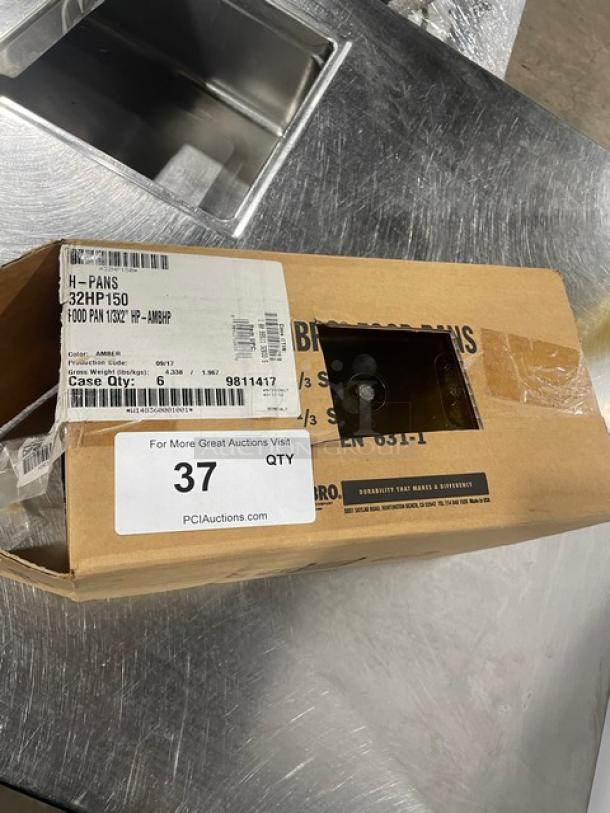 Brand new Cambro 32HP150 commercial amber 1/3-size 2" food pan in box, high-temperature resistant, with labels visible.