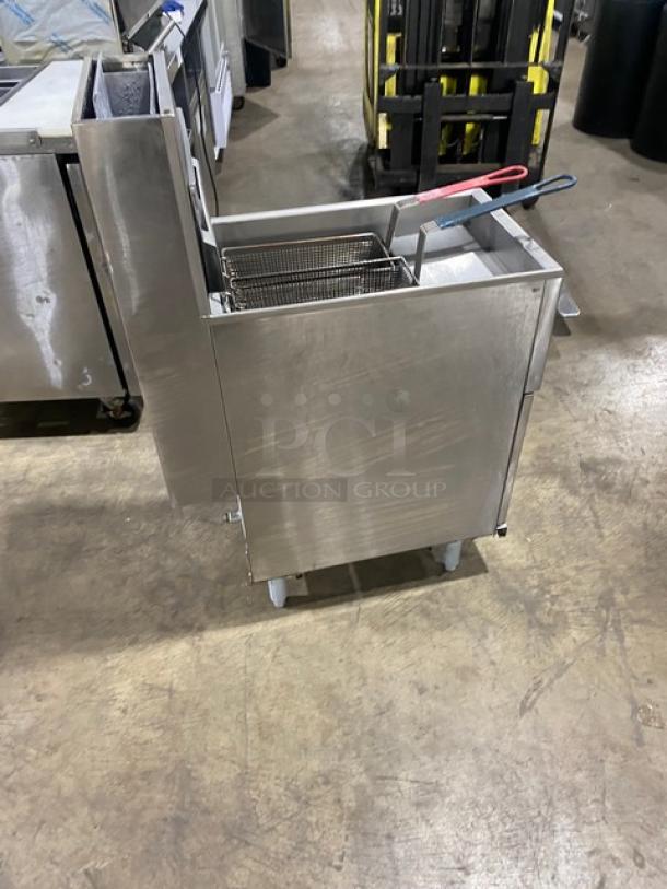 Pitco commercial stainless steel 40 lb. deep fat fryer with back splash, basket hanger, and fry baskets, on legs.