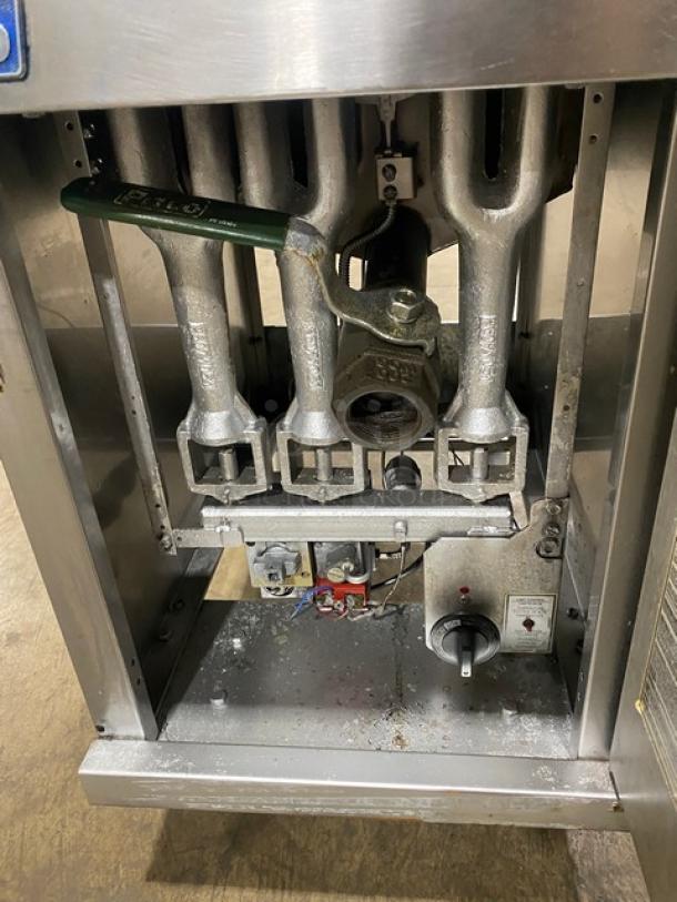Pitco commercial stainless steel natural gas fryer, 40 lb. capacity, with backsplash, basket hanger, and fry baskets, on legs.