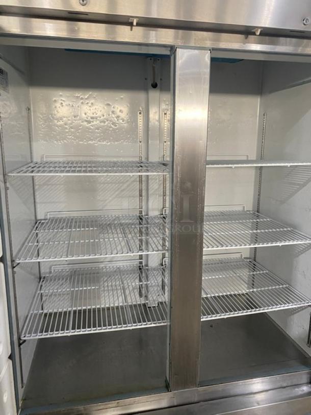 Arctic Air AR49EZ stainless steel refrigerator with two solid doors, poly coated wire racks, and casters, model SN H22116788.