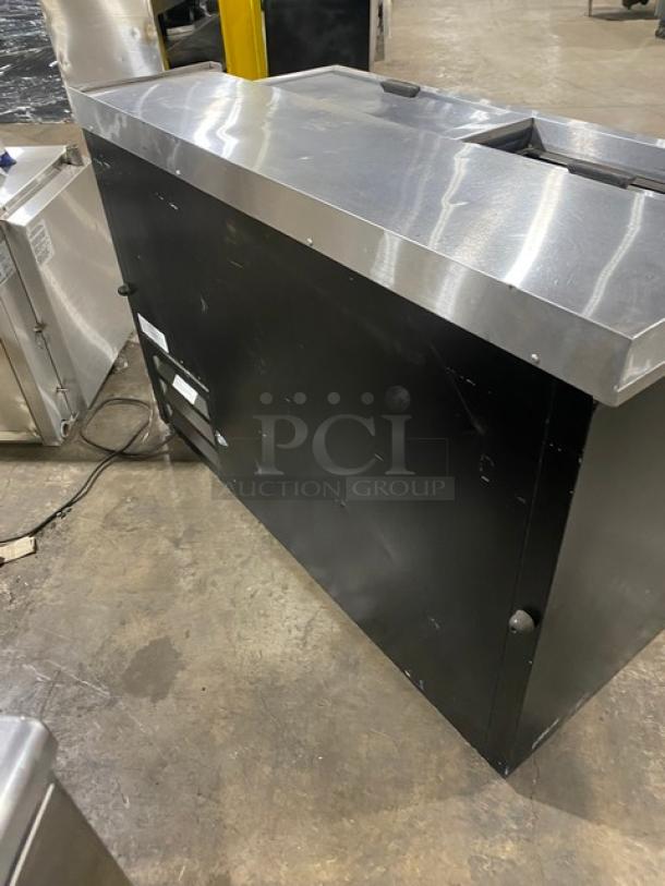 Fogel BC50DBST back bar bottle cooler, black powder-coated, stainless steel top, double sliding lids, 115V, good condition.