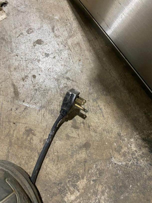 Alt text: Fogel BC50DBST cooler plug on concrete floor, black three-prong design, part of commercial back bar equipment.