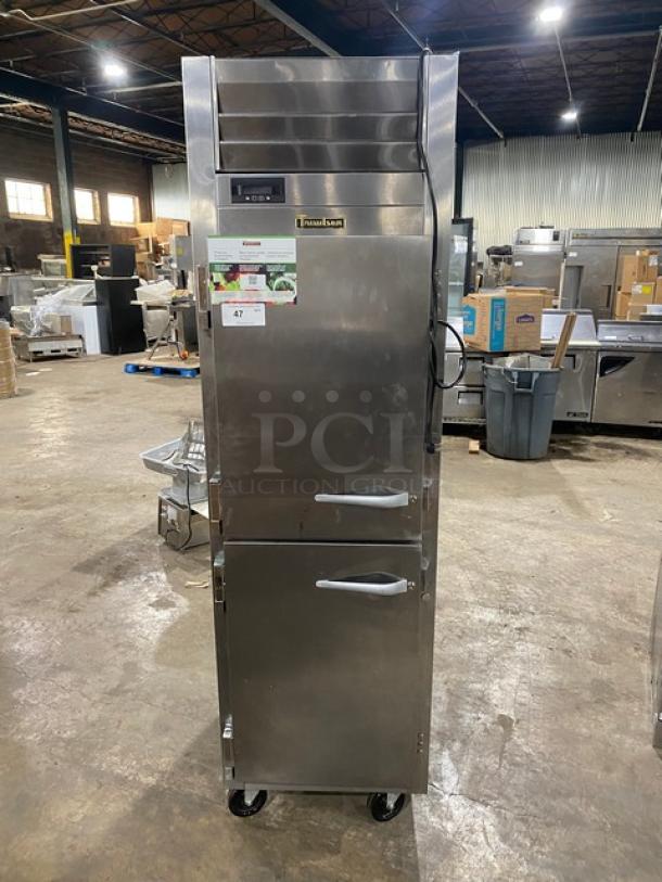 Traulsen stainless steel commercial half door reach-in refrigerator, model AHT132DUTHHS, on casters, with wired racks.