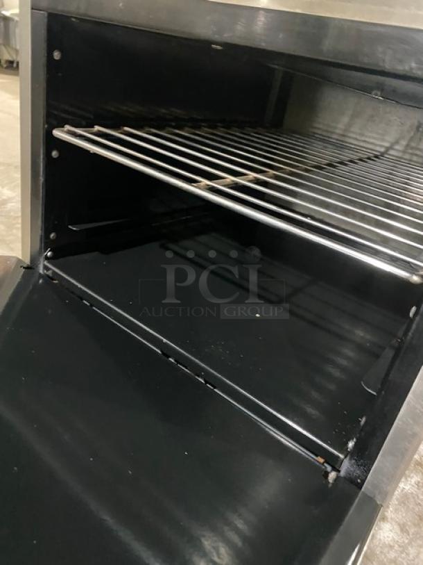 American Range stainless steel flat top range/oven combo, natural gas, includes wired oven rack, mounted on casters.