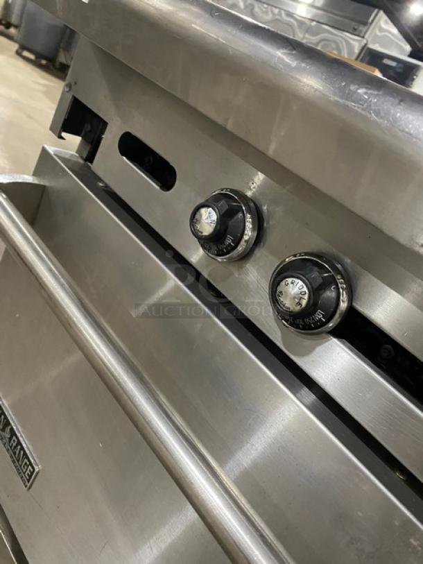 American Range commercial stainless steel natural gas flat top range/oven combo with wired oven rack and casters, in used condition.