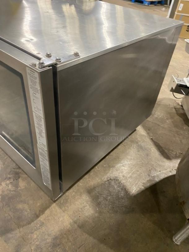 Rational SCCWE62G commercial stainless steel 6-pan combi oven, Energy Star certified, with gas hose and wired racks.