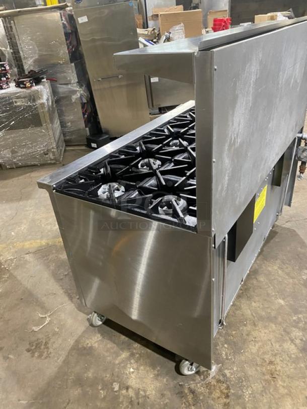 Garland SunFire Series 10-burner stainless steel range with double oven, backsplash, overhead salamander shelf, and casters. Model X60-10RR.