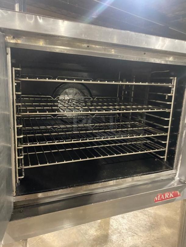Blodgett stainless steel electric convection oven with thermostatic controls, wired racks, and legs.
